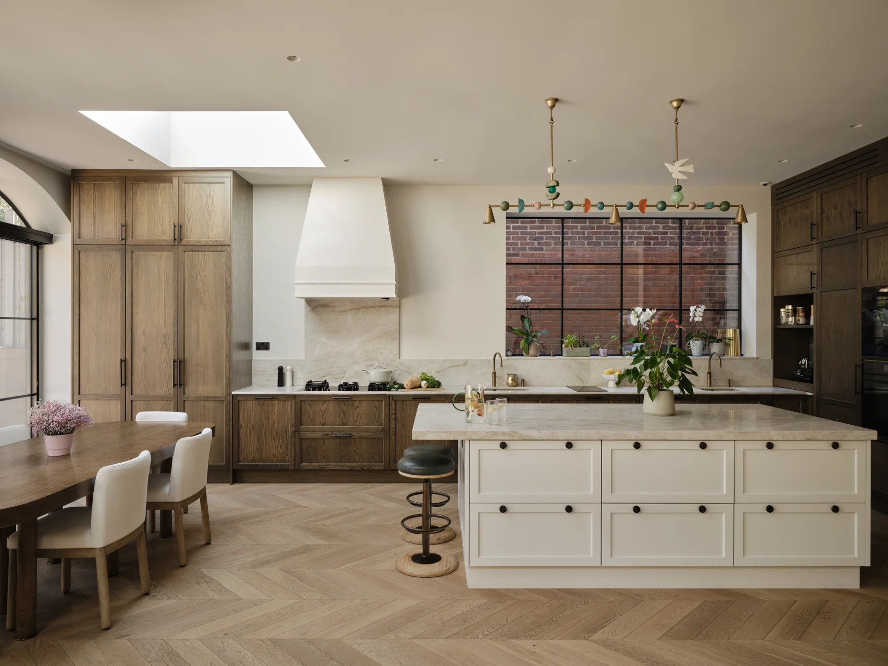 The Kosher Kitchen — Rich timber cabinetry paired with a pale central island.