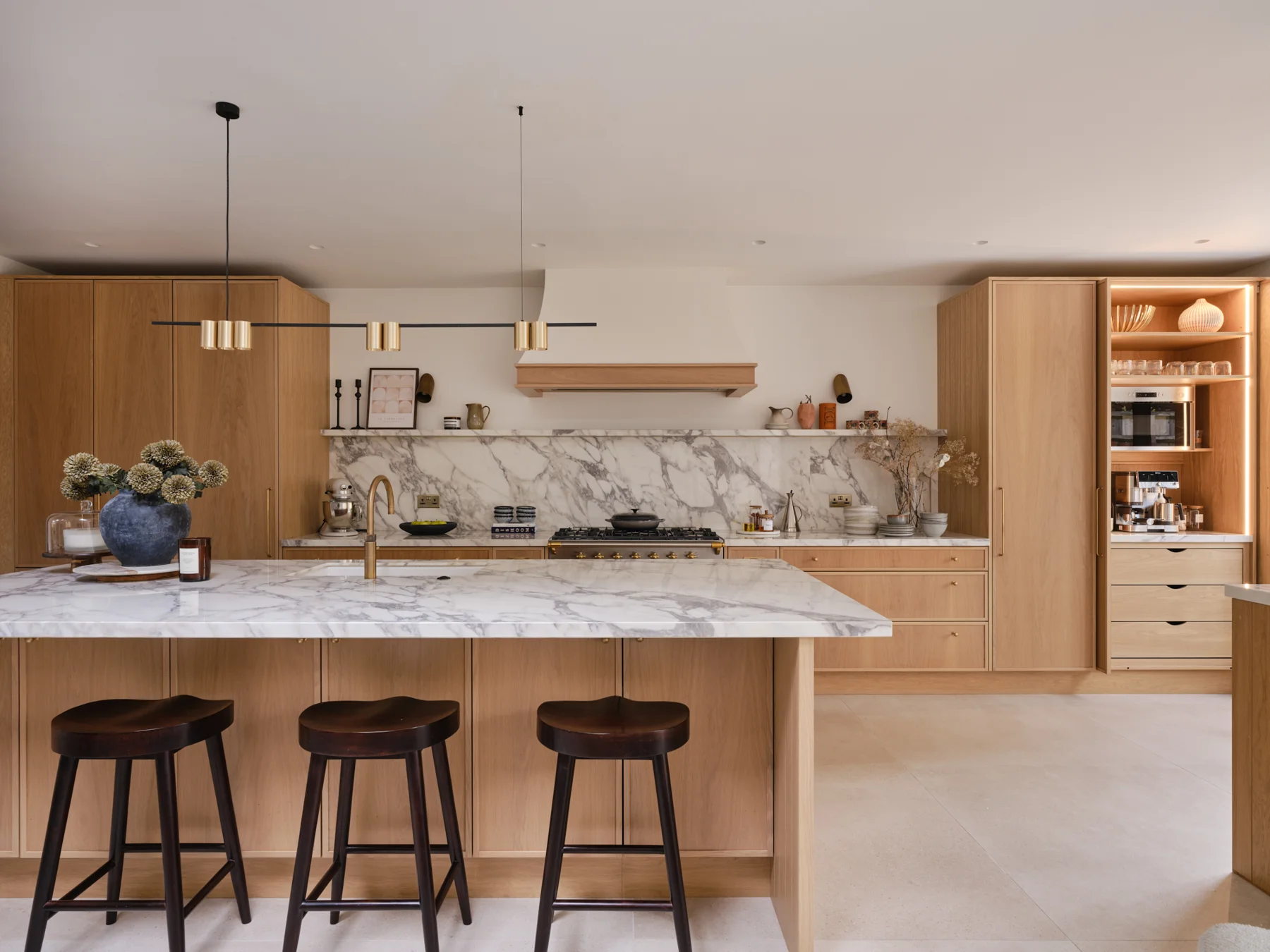 The Modern Sanctuary — Warm timber cabinetry, pale stone and a generous breakfast island.