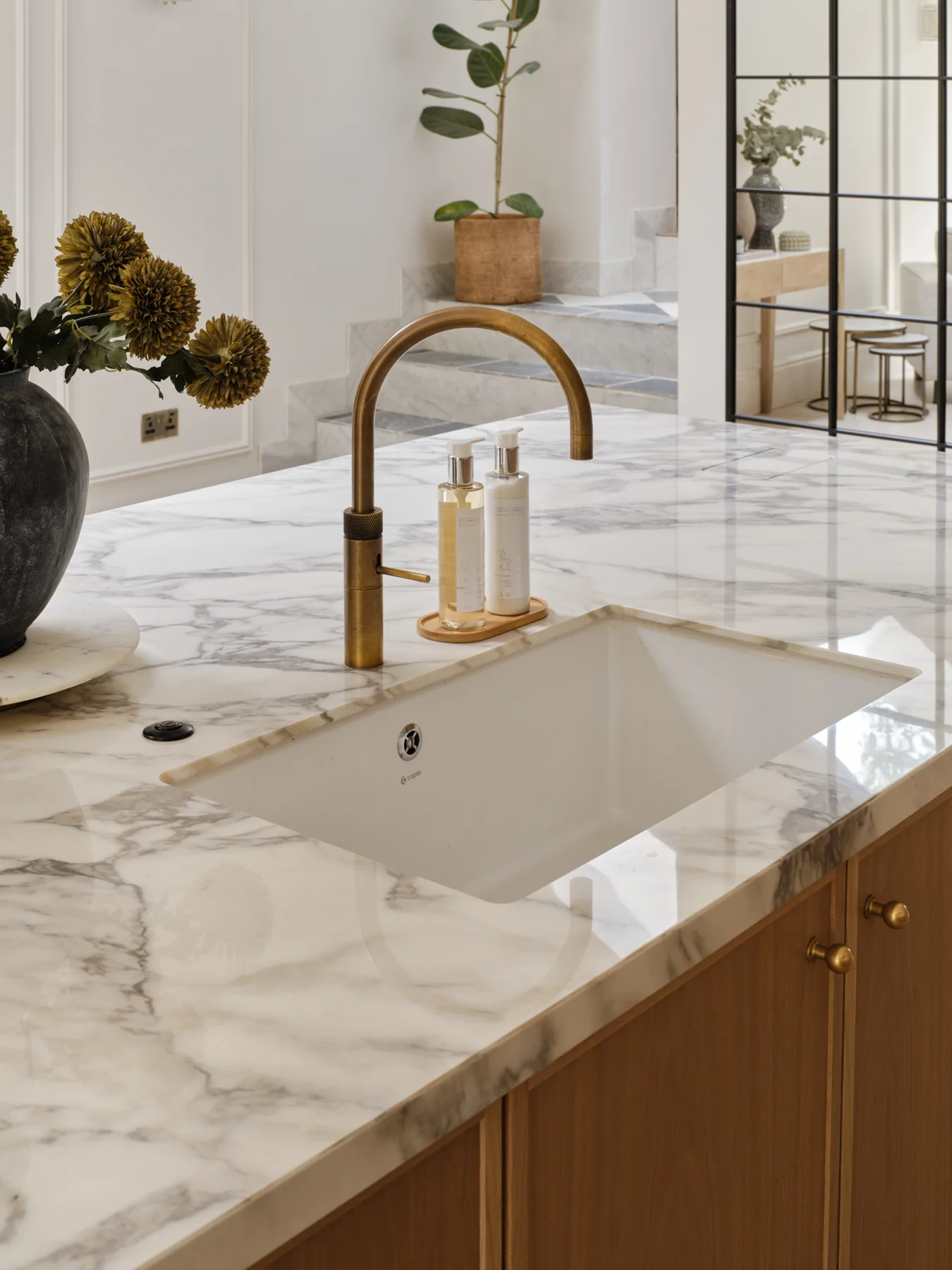 The Modern Sanctuary — Brass tap and inset sink on the stone island.